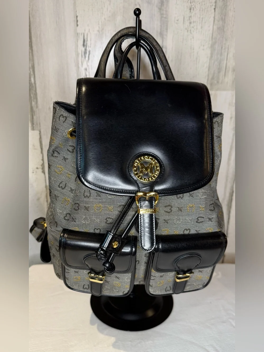 Metrocity Signature Canvas Backpack with black leather trim and gold hardware